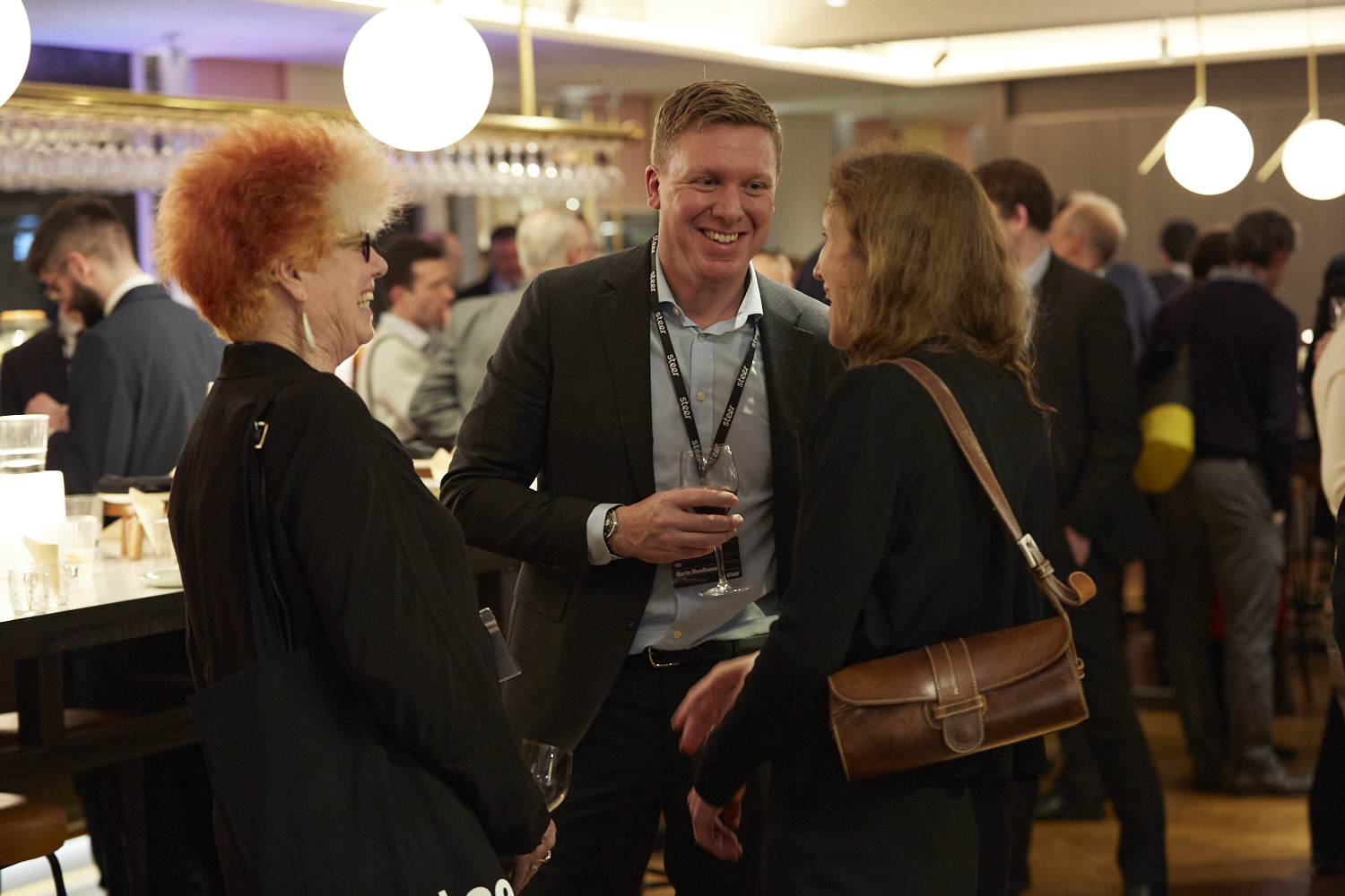 Attendees talking and laughing